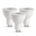 Three white GU10 LED spotlight bulbs on a white background