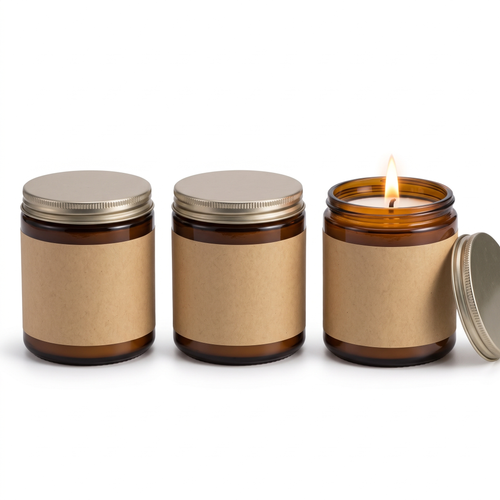 Three amber glass jar scented candles with metal lids on a white background